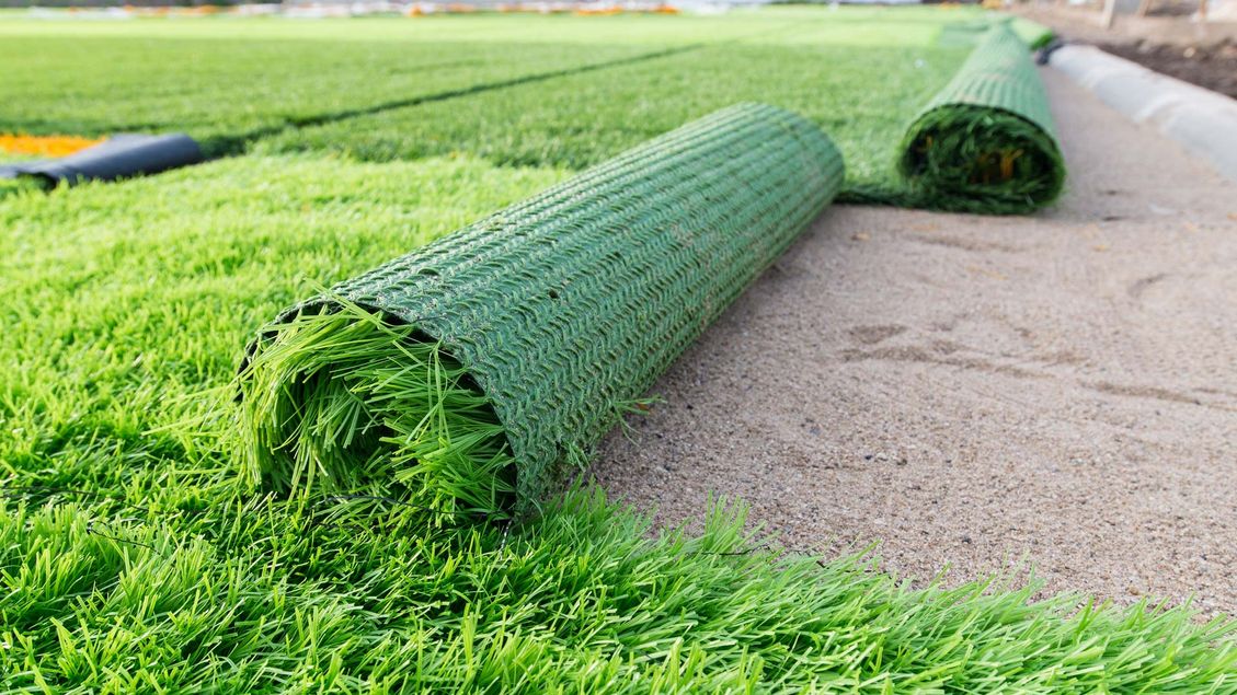Artificial grass that is being laid by our team